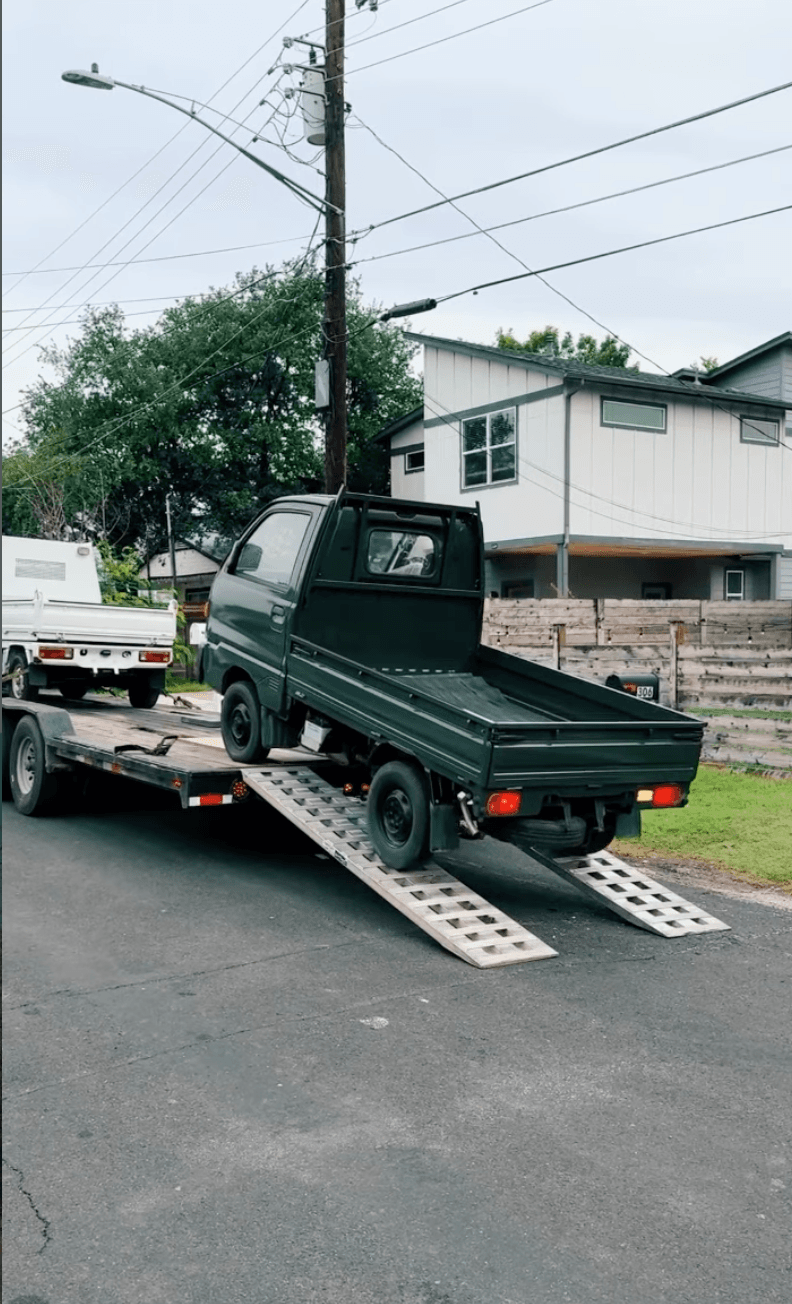 Mini truck arriving on a flatbed